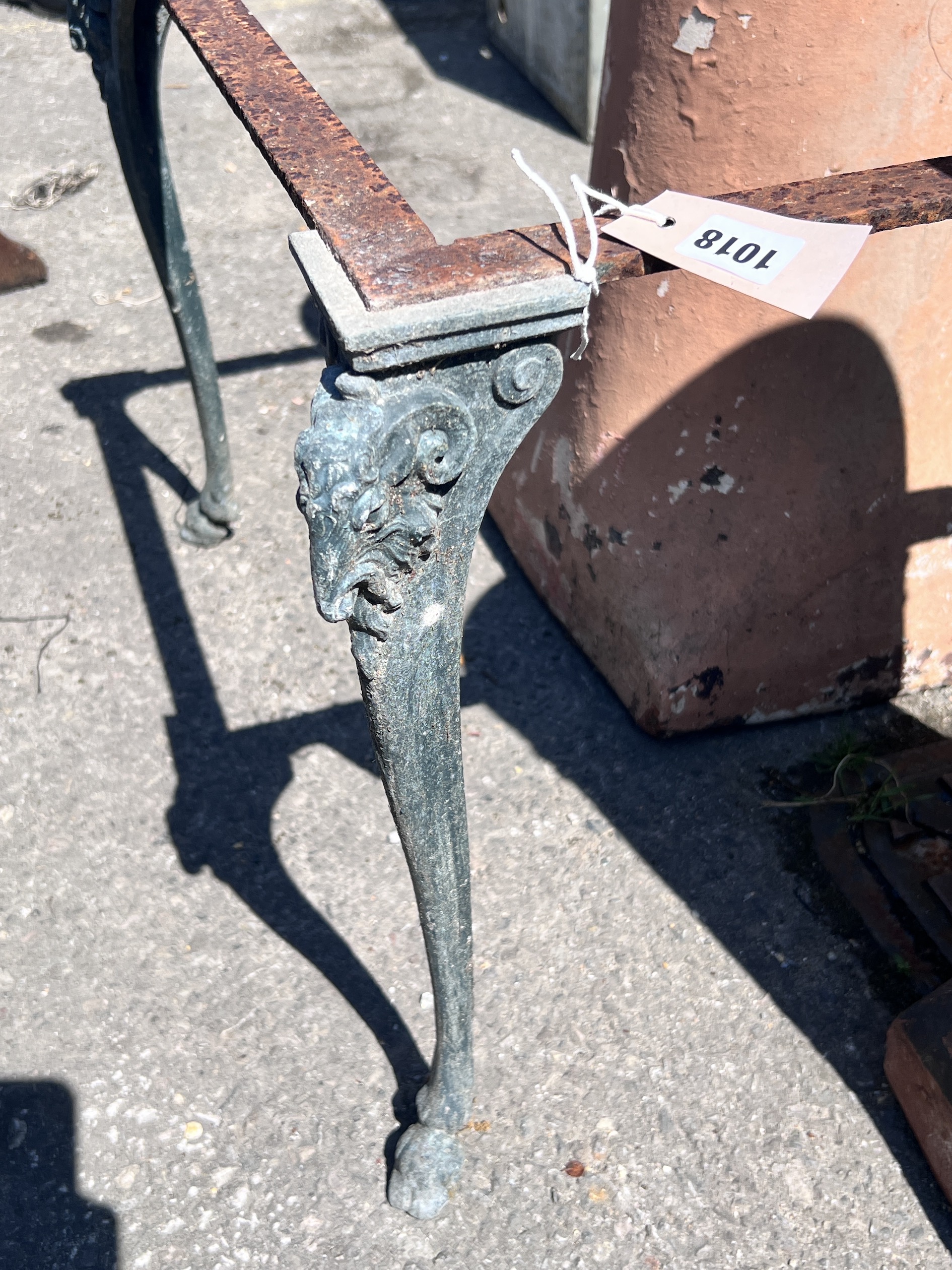 Two terracotta chimney pots, height 77cm, together with a square metal table frame